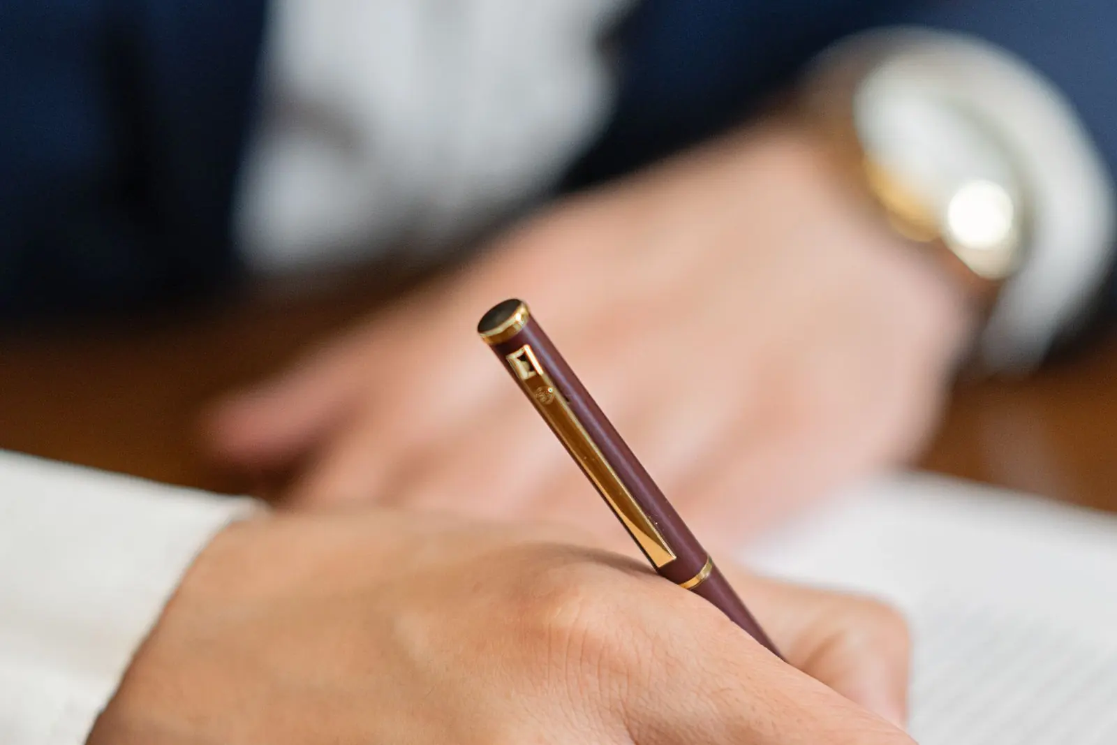 Attorney signing a demand letter with a fountain pen
